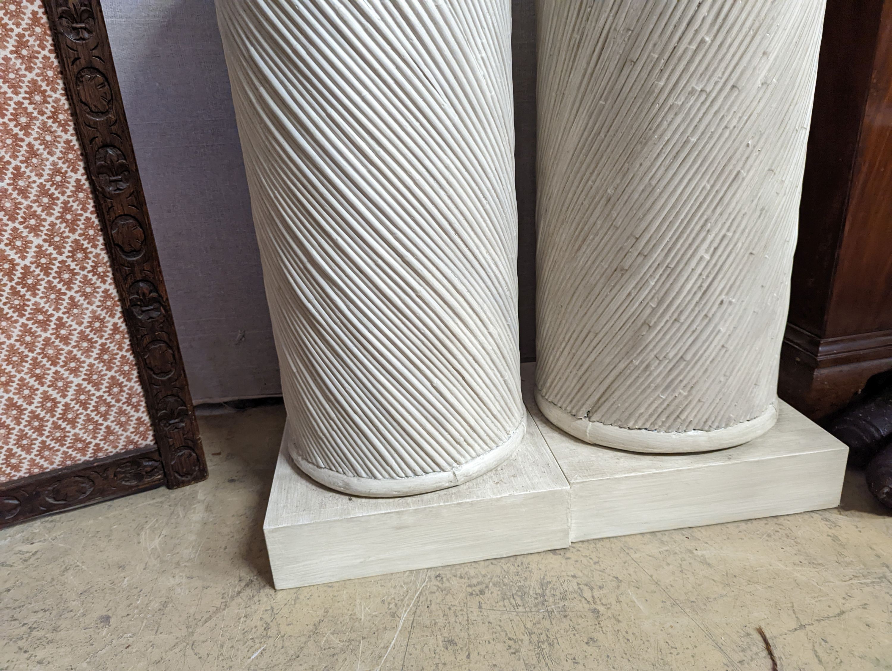 A pair of painted spiral moulded columns, Colefax & Fowler, diameter 30cm, height 79cm